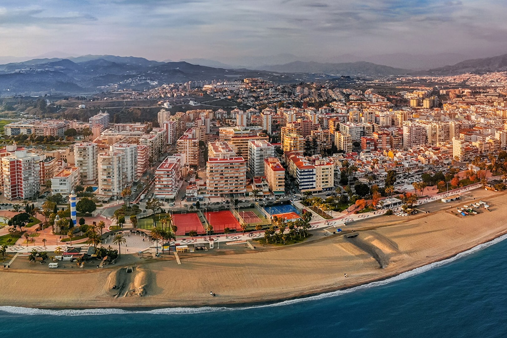 The image is an aerial view of the coastal town of Torre del Mar,