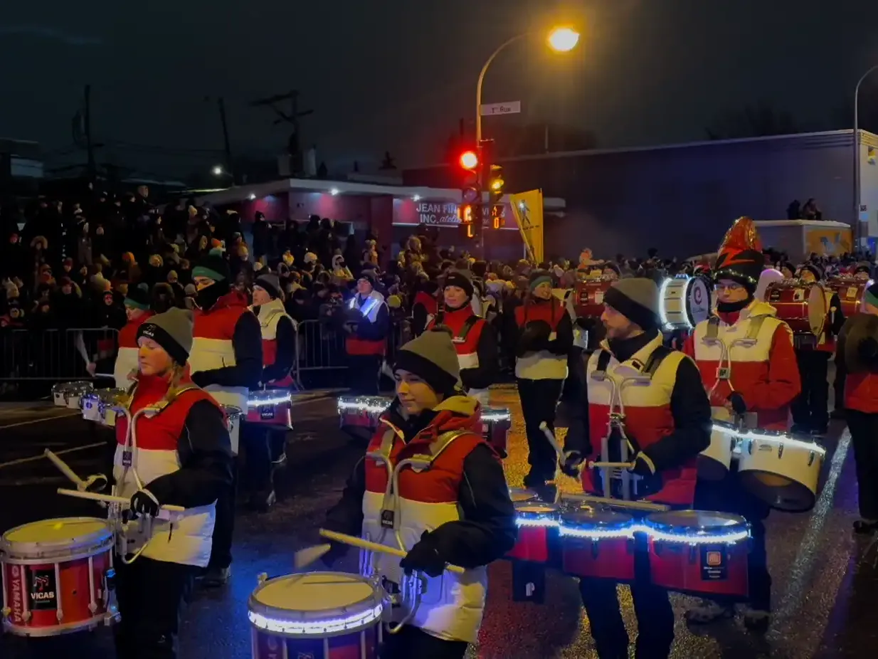 School marching band delivering a electric performance at winter carnival parade 2026