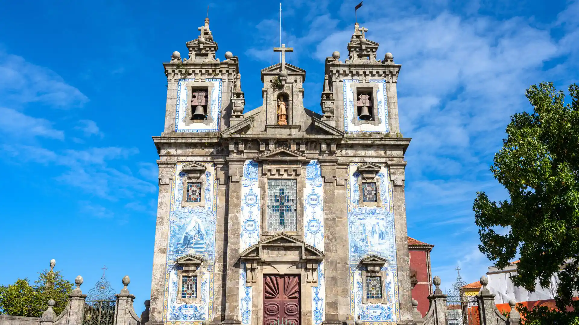 Thousands of hand-painted azulejo tiles cover the façade of Santo Ildefonso Church in Porto.