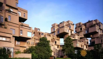 Habitat 67 in Montreal viewed from the waterfront, showing the stacked concrete modular housing units arranged in irregular geometric forms