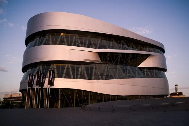 The Mercedes-Benz Museum in Stuttgart is as much a work of architecture as a celebration of automotive history, its spiraling steel form glowing at dusk