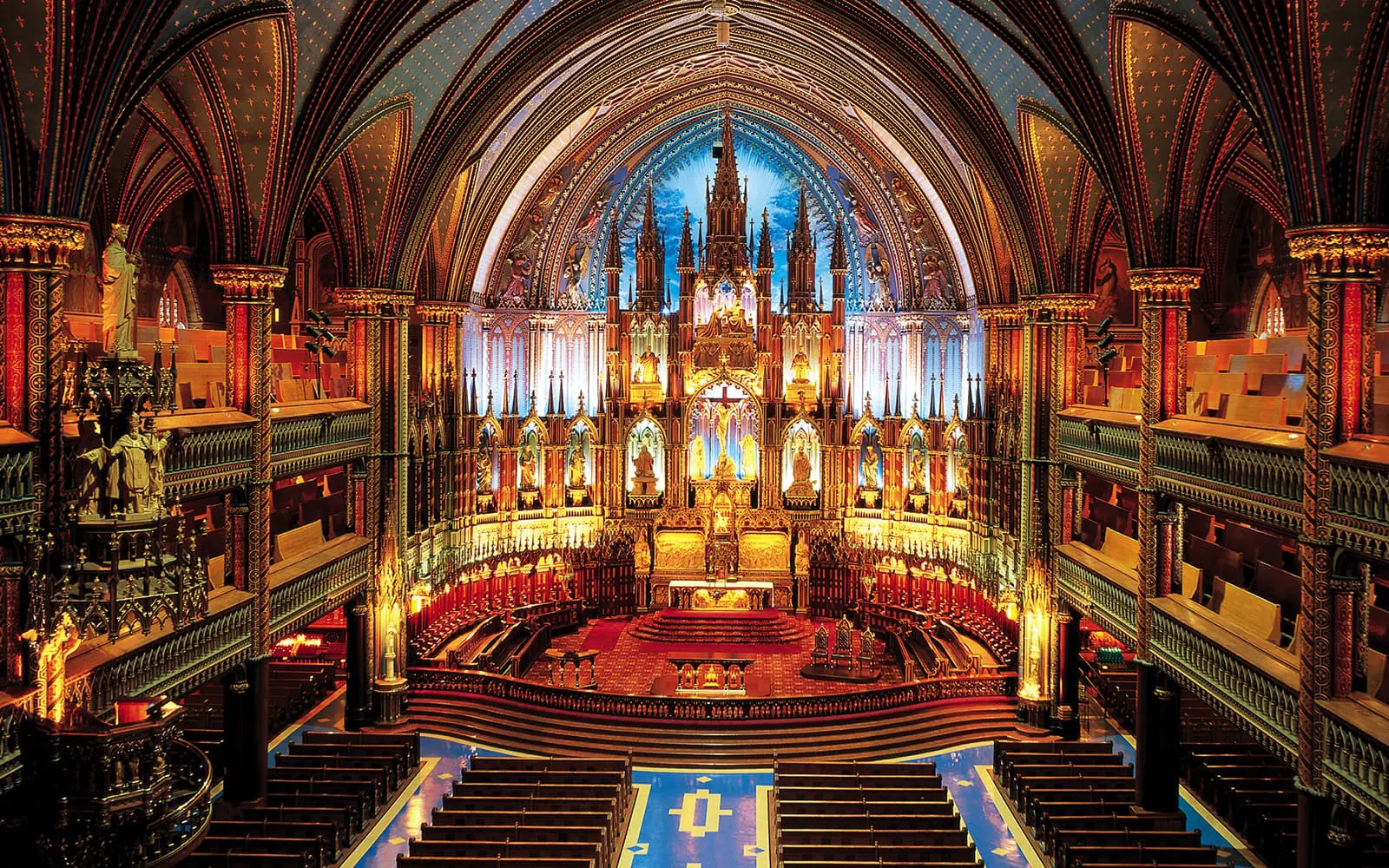 Notre-Dame Basilica in Montreal dazzles with its midnight blue vaulted ceiling, gilded wood carvings, and vivid stained glass windows