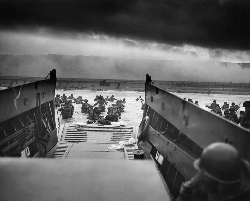 Taken from the open ramp of a landing craft, this iconic D-Day image shows US troops storming ashore at Omaha Beach in 1944