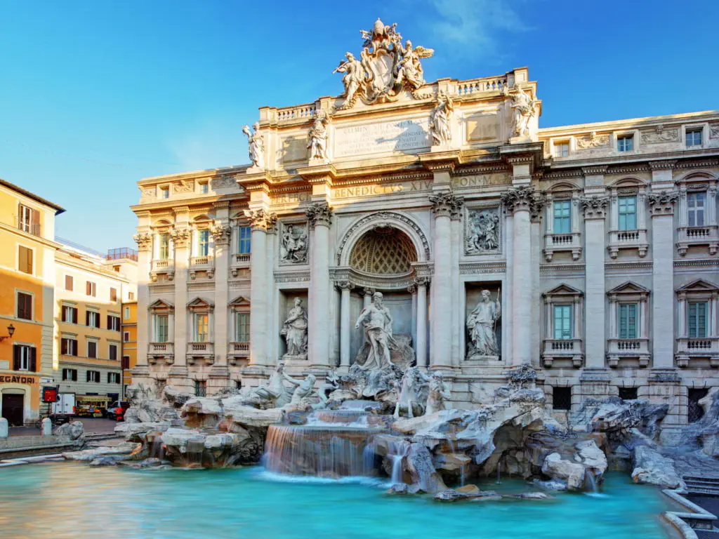 The Trevi Fountain fills the Piazza di Trevi in Rome, where Neptune presides over a sculpted drama of tritons and sea horses against a Baroque palace facade