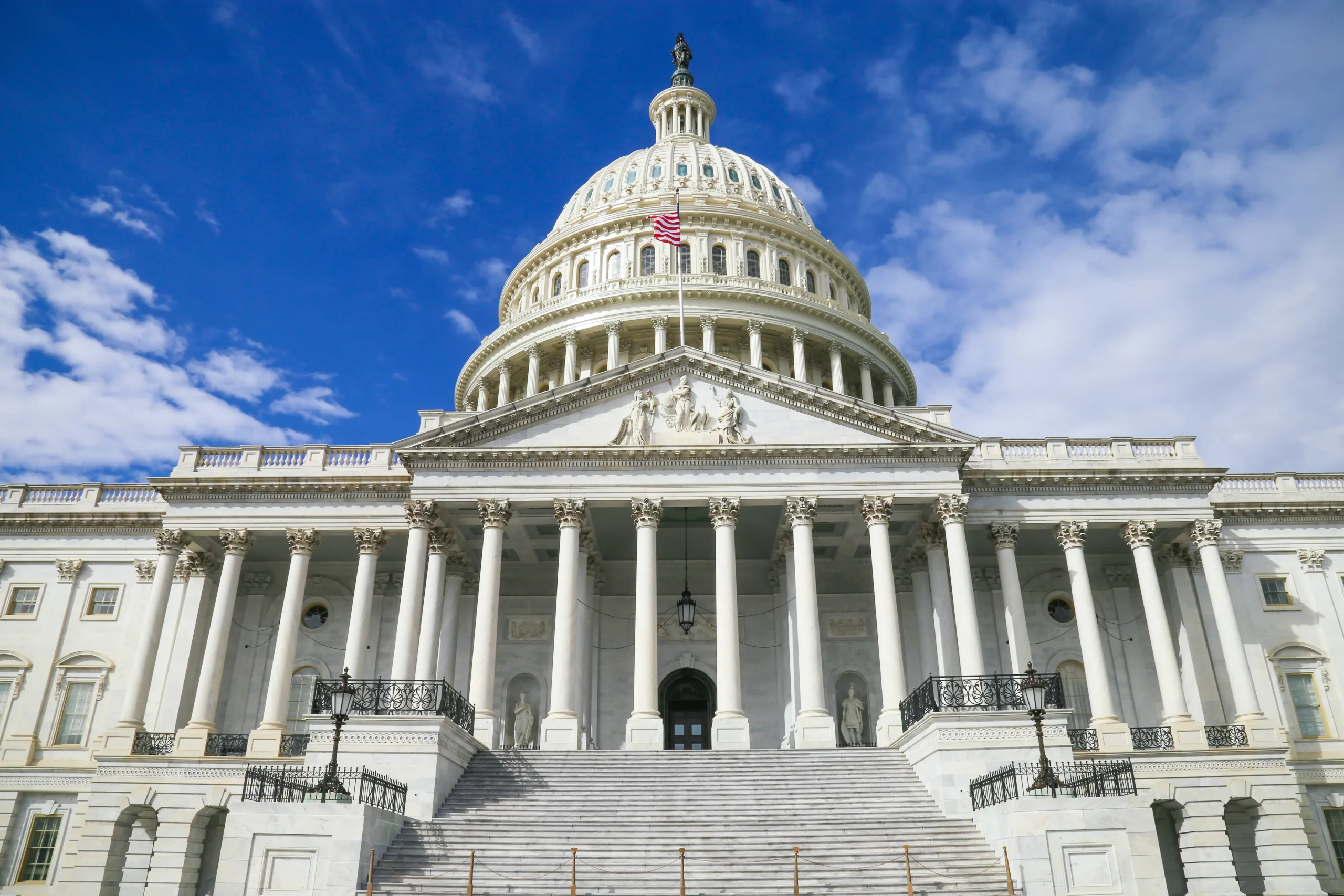 The US Capitol building's white neoclassical dome and columned facade stand as the defining symbol of American democracy in Washington DC