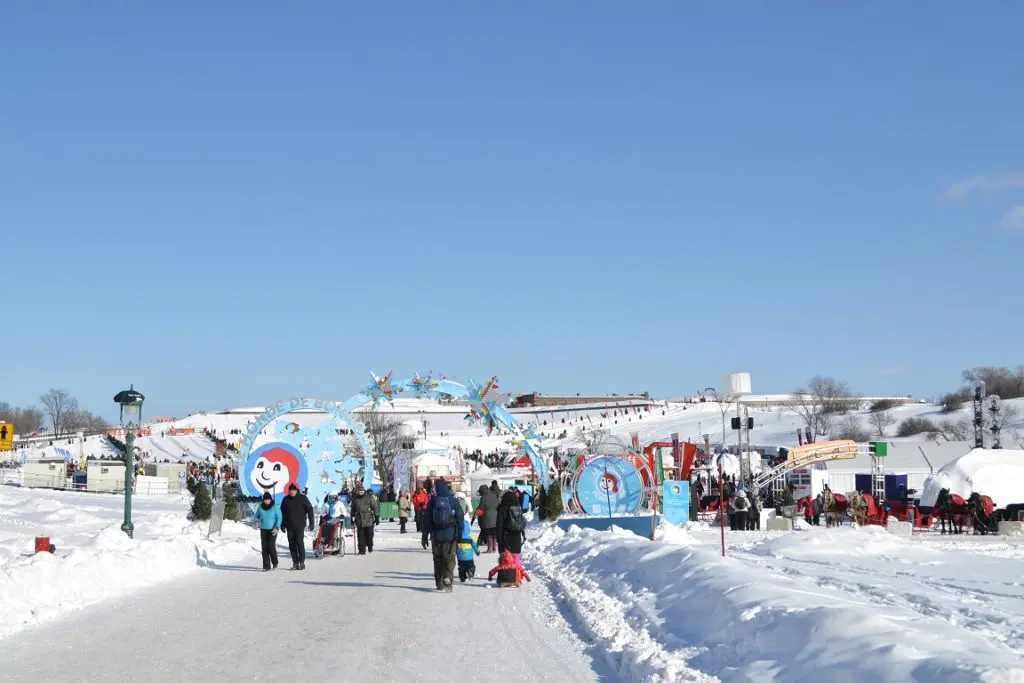 Illuminated ice sculptures and snow art installations light up the Quebec City Winter Carnival grounds after dark